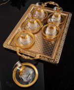 tea set with saucers with gold rim.